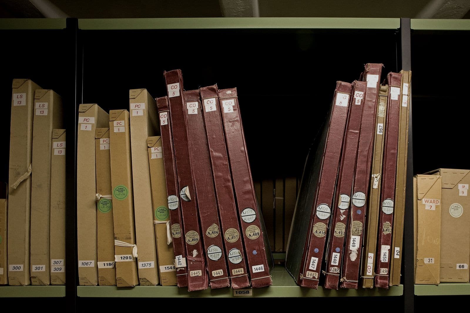 Bound registers and labelled document boxes on archive repository shelving