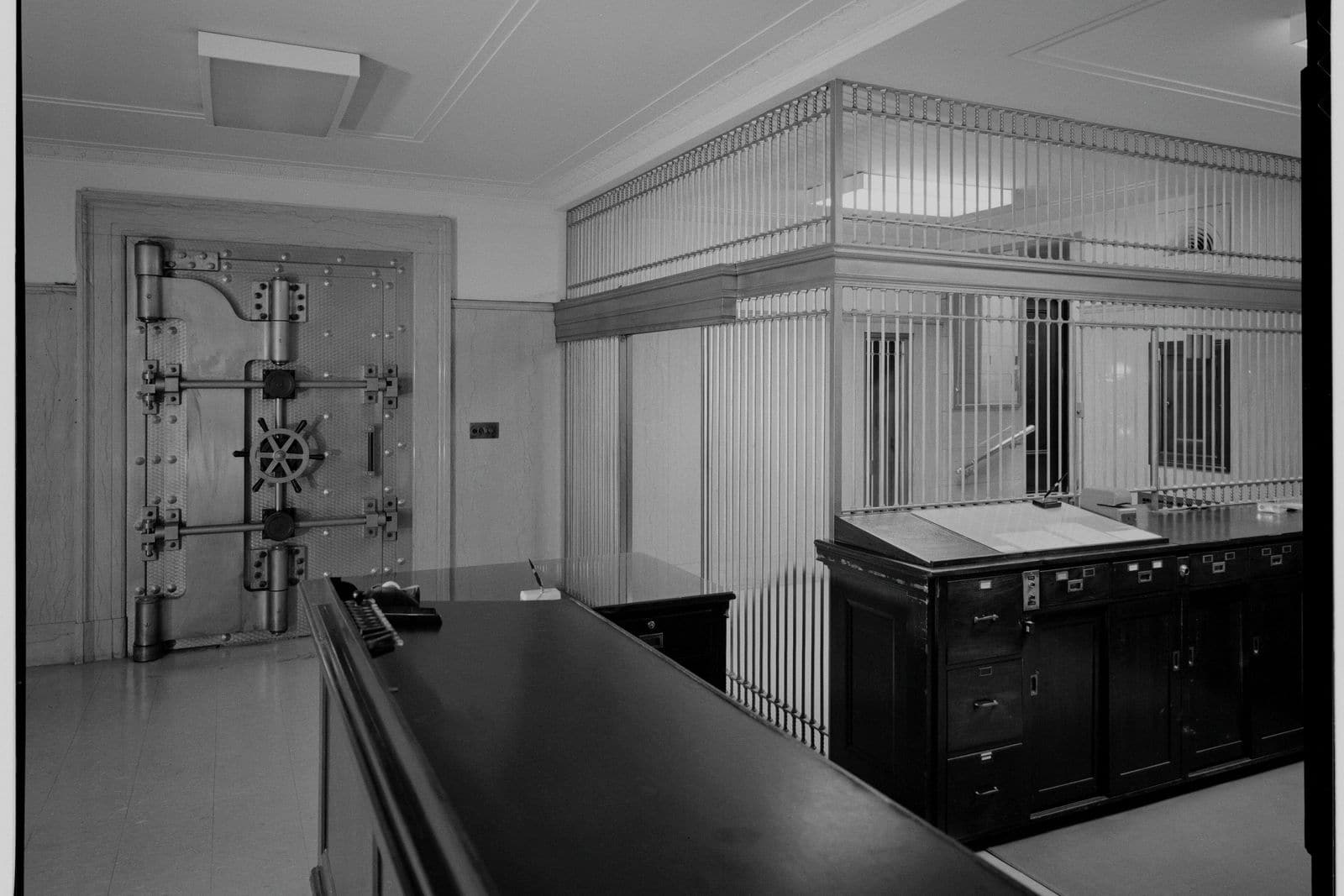 The lobby of a bank safe deposit vault, the vault door standing open